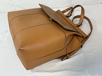 Side/bottom perspective highlighting leather, seams and bottom structure