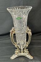 Full view of crystal vase mounted on ornate silver-plated base