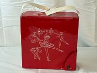 front view of red vinyl ballet box with ballerina graphics and handle