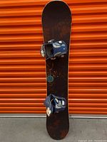 Full view of snowboard front with bindings attached