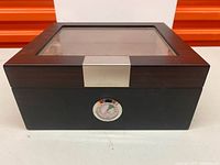 Closed humidor front view showing glass top and hygrometer