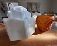 White milk glass and amber frosted glass shades side by side