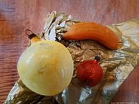 All three vintage glass fruit ornaments on tissue paper