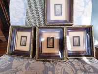 All four framed miniature prints displayed together