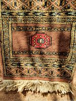 Full view of the wool table mat showing design, colours and fringe