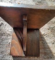 Shelf viewed from above showing top, support bracket and wood grain