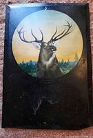 Front of tin panel showing stag image and hanging hole