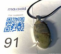 Front view of pendant on black cord showing jasper stone
