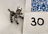 Poodle pendant profile showing articulation and hallmarked silver finish