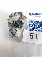 Front view of mineral showing black tourmaline veins in white matrix