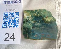 Top view showing polished face of bloodstone next to scale card