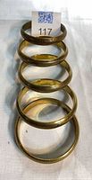 Five brass bangles stacked vertically showing overall appearance