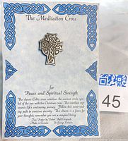Front view of pewter Celtic cross pin on informational card