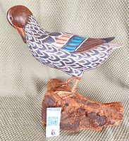 full left side view of carved duck on wood base