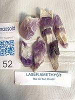 Six laser amethyst points with lot tag and origin label