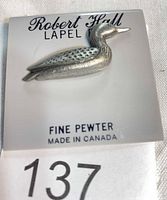 Front view of pewter loon pin on Robert Hall card
