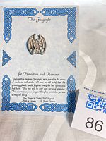 Front view of pewter gargoyle pin on branded card