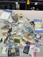 Lot overview showing beads, findings, tools, spools, packaging