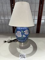 Full lamp with shade, power cord visible