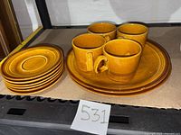 Group shot showing all 12 pieces: 4 cups, 6 saucers, 2 dinner plates