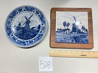Plate and framed tile side by side with ruler for scale
