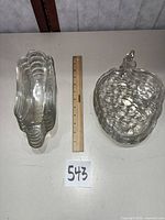 Stacked banana split dishes and grape snack plates with 12-inch ruler for scale