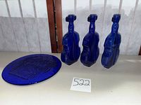 Overview of three violin bottles and round plate