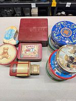 Group shot of all 11 tins showing variety of shapes and graphics