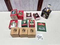 All 12 boxed ornaments and figurines arranged on table