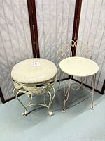 Front view of both cream wrought iron vanity stools