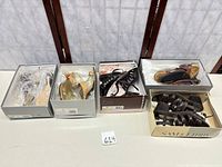 Five shoeboxes each containing a pair of sandals