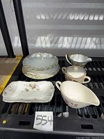 Group shot of all five porcelain serving pieces on shelf