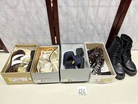 All five pairs in boxes and boots displayed