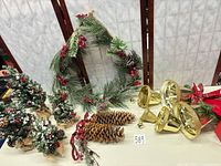 Lot overview showing trees, wreath, pinecones and bells
