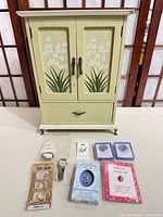 Full view of armoire with jewelry items arranged in front