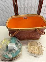 Open Redman picnic basket, bagged plastic dishes, rattan tray