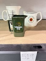 All three ceramic advertising pitchers grouped together