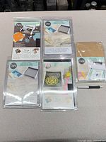 All five sealed Sizzix accessory packages laid out on tabletop