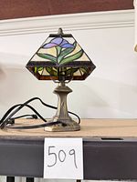 Full view of small stained glass lamp on shelf