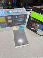 YourStory Photo kit box, sealed laminate pouch pack and HP Photo Value Pack displayed together