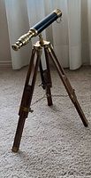 Brass telescope mounted on wooden tripod