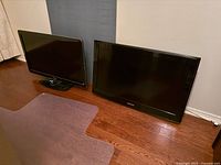 Front view of both televisions side by side on floor