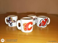 Four miniature mugs showing front team logos: Florida Panthers, Calgary Flames, New Jersey Devils