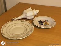 Two plates and conch shell on table