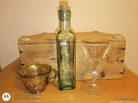 Bottle, teacup and martini glass front view