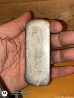 Front of pewter ingot held in hand