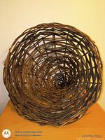 Front view into opening of woven wicker cornucopia basket