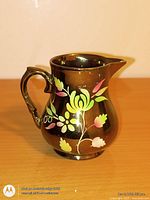 Front view of brown lustre floral pitcher