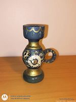 Front view of hand-painted wood candle holder