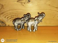 Both metal elephant figurines side by side